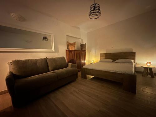 a living room with a bed and a couch at Mariella Vernile in Civitella Roveto