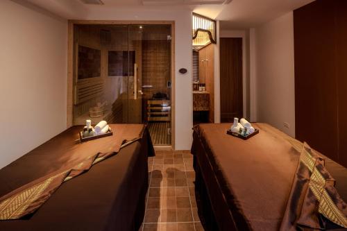 a room with two beds with candles on them at Away Chiang Mai Thapae Resort A Vegan Retreat in Chiang Mai