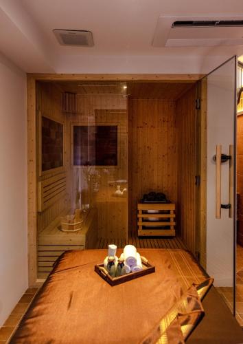 a room with a bed and a bathroom with a tub at Away Chiang Mai Thapae Resort A Vegan Retreat in Chiang Mai