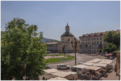 a large building with a street with tents in front of it at Carlina Charme 10 minutes from Porta Nuova - WIFI in Turin