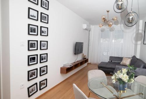 a living room with a table and a couch at Birkin Casa- Prime Location in Novi Sad