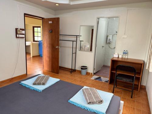 a room with two towels sitting on the floor at Tommy apartment in Koh Tao