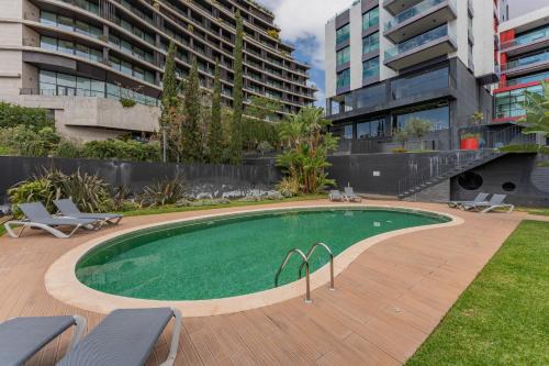 a swimming pool in the middle of a building at FLH Funchal Elegant Apartment with Pool & Balcony in Funchal