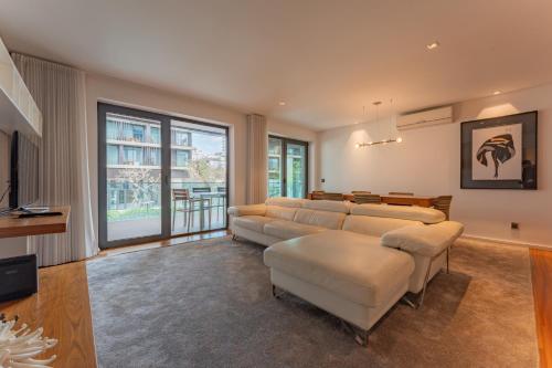a large living room with couches and a television at FLH Funchal Elegant Apartment with Pool & Balcony in Funchal