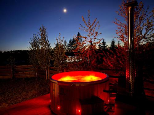 a hot tub on a deck at night at Monialuki in Nogat