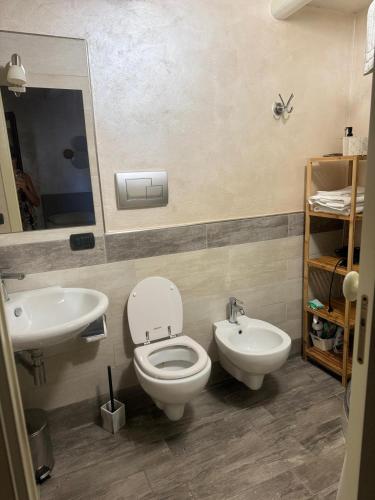 a bathroom with a toilet and a sink at MINOA Relax in Agrigento