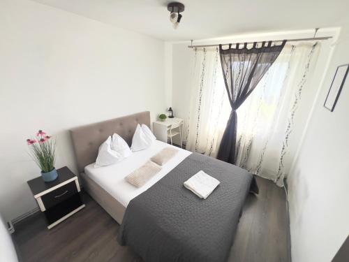 a small bedroom with a bed and a window at City Charm -3 rooms with free Parking in Iaşi