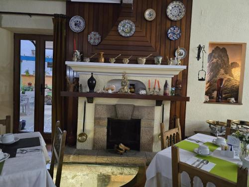 a living room with a fireplace and a table and chairs at Hosteria Picos De Europa in Potes