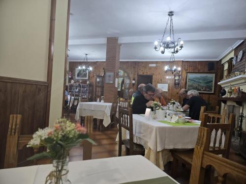 a group of people sitting at tables in a restaurant at Hosteria Picos De Europa in Potes