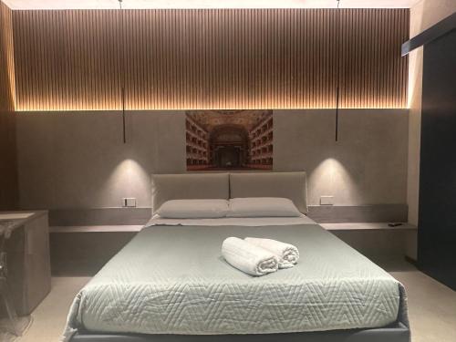 a bedroom with a bed with a towel on it at Zen escape Sicilia in San Gregorio di Catania