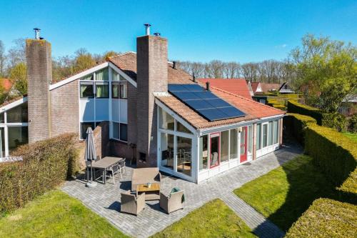 an overhead view of a house with a solar roof at Kievit I Spacious Bungalow with Fine Garden in Zwiggelte