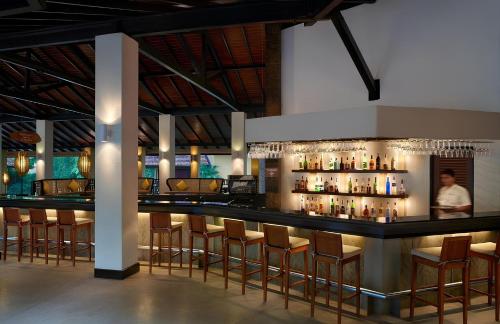 a bar in a restaurant with bar stools at Habarana Village by Cinnamon in Sigiriya