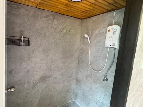 a shower in a bathroom with a shower at Penny Hostel & Cafe in Thongsala