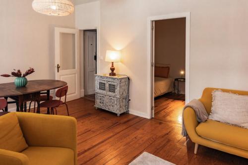 a living room with a couch and a table at SUNNY PATIO Apartment in Lisbon