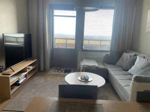 a living room with a couch and a table at Ylläs chalet Bella Vista in Ylläsjärvi