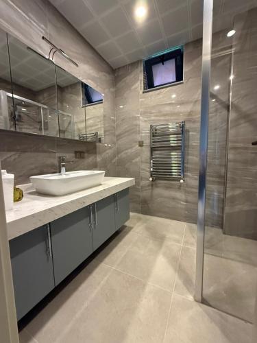 a bathroom with a sink and a shower at villa trapeza in Trabzon