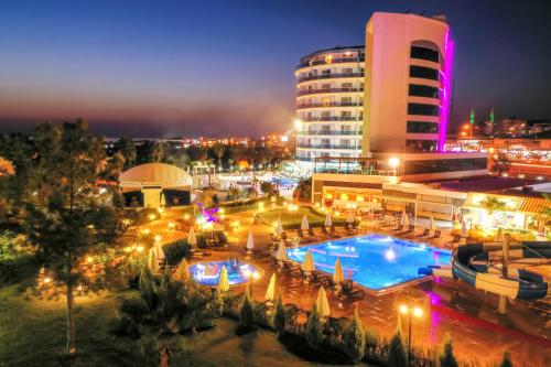 a resort with a pool and a building at night at The Marilis Hill Resort Hotel & Spa Ultra All Inclusive in Okurcalar