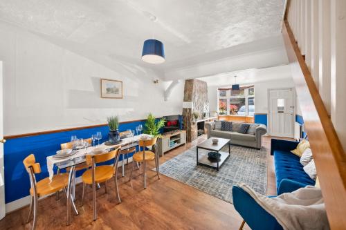 a living room with a blue accent wall at Heartwarming Windsor Cottage with Free Parking - Perfect for Contractors, Relocators and Long Term Stays! Weekly And Monthly Stay Deals in Windsor