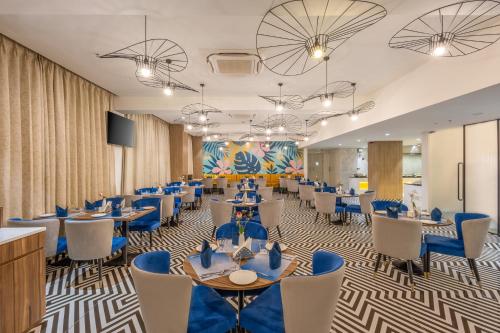 a conference room with tables and chairs and a flat screen tv at Effotel by Sayaji Navi Mumbai in Navi Mumbai