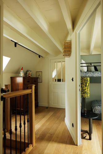 a room with a staircase and a room with a bed at Domaine de Locguénolé & Spa - Relais & Chateaux in Kervignac