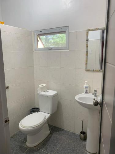 a bathroom with a toilet and a sink at Villa Marquez in Camotes Islands