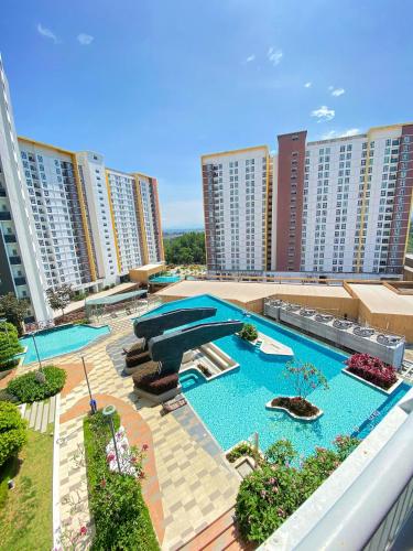 an outdoor swimming pool on a building with tall buildings at 2 Bedrooms Suites at Mesahill Nilai with Mall by D'KAY HOMES, near USIM KLIA in Nilai