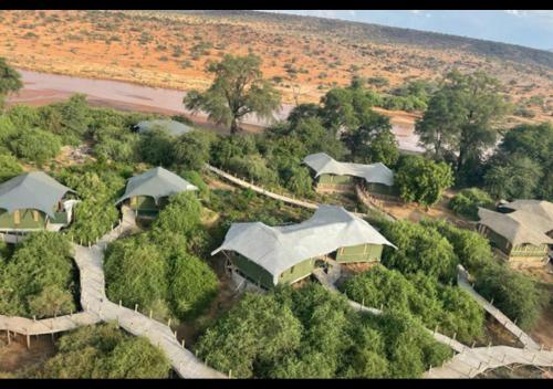 an aerial view of a group of houses with trees at Samburu Elephant Lodge in Isiolo