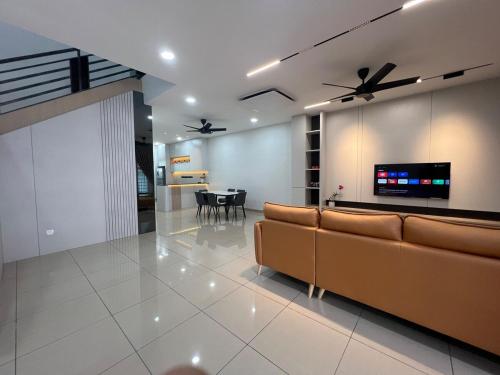 a living room with a couch and a table at 5 min to AeonBig , Old Street, BP Mall & D Garden Batu Pahat in Batu Pahat