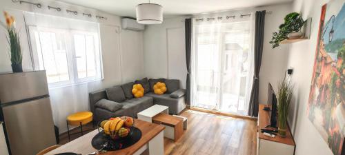 a living room with a couch and a table at Klaudija in Igalo