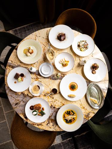a table with plates of food on top of it at Domaine de Locguénolé & Spa - Relais & Chateaux in Kervignac