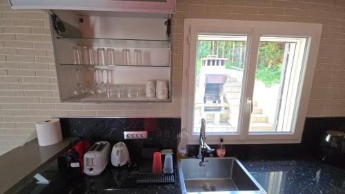 a kitchen counter with a sink and a window at Beautiful Family House near Paris in Villeneuve-Saint-Georges