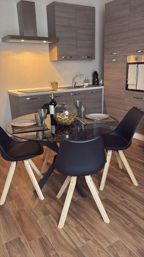 a kitchen with a glass table and two chairs at Casa Rachele in Taranto