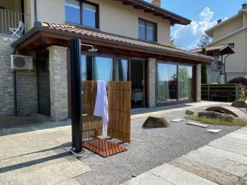 a house with a wooden fence in front of it at Stanze Degli Aceri in Murazzano