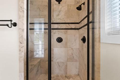 a shower with a glass door in a bathroom at Inlet Breeze in Inlet Beach