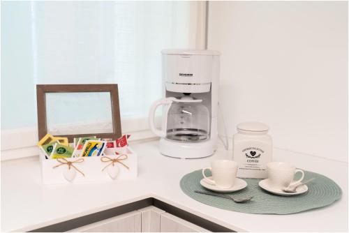 a kitchen counter with a coffee maker and two cups at Tiffany Silver in Burano