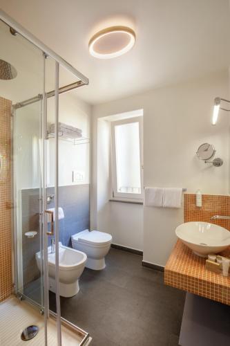 a bathroom with a toilet and a sink and a shower at Vivaldi Luxury Rooms in Rome