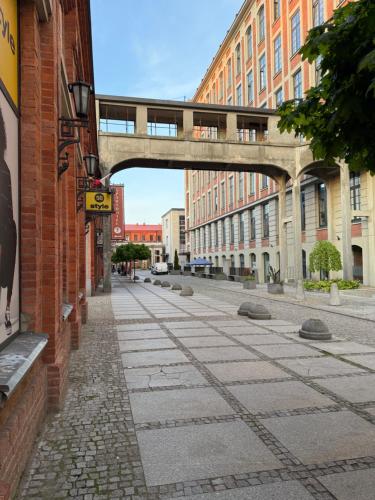 an empty street with a bridge in a city at Loft Studio in Żyrardów