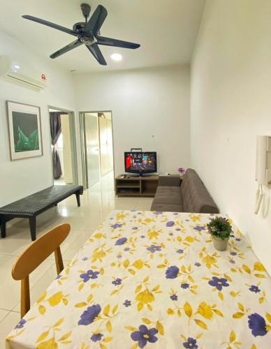 a living room with a table and a ceiling fan at 2 Bedrooms Suites at Mesahill Nilai with Mall by D'KAY HOMES, near USIM KLIA in Nilai