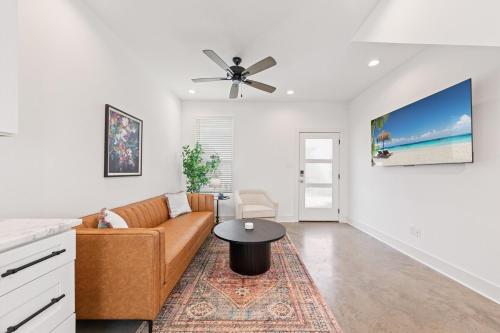 a living room with a couch and a table at NEW Couyon House Luxury Amenities Fast WiFi 65 TV in Lafayette