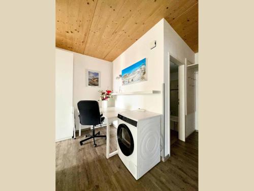 a room with a washing machine and a desk at Landhaus Almidyll in Seefeld in Tirol
