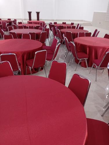 a room filled with red tables and chairs at Skyline View Hotels and Suites in Mama