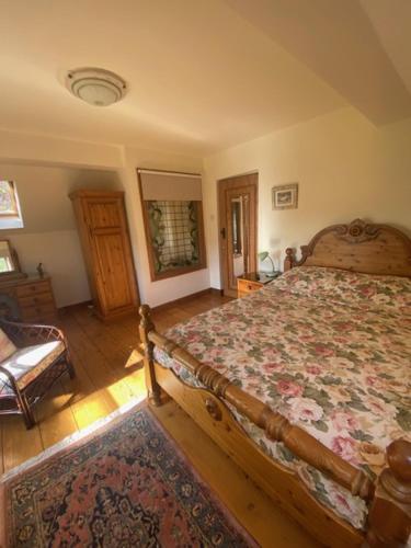 a bedroom with a bed and a chair in it at Beech Farm cottages in Tetney