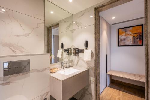 a bathroom with a sink and a shower at Effotel by Sayaji Navi Mumbai in Navi Mumbai