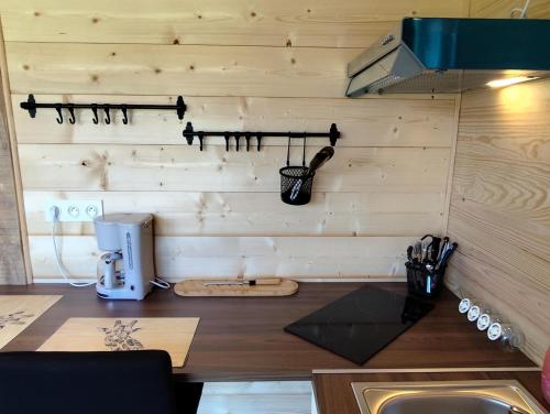 a kitchen with a counter with a coffeemaker and a counter sidx sidx sidx at Woodstudio in Gaujacq
