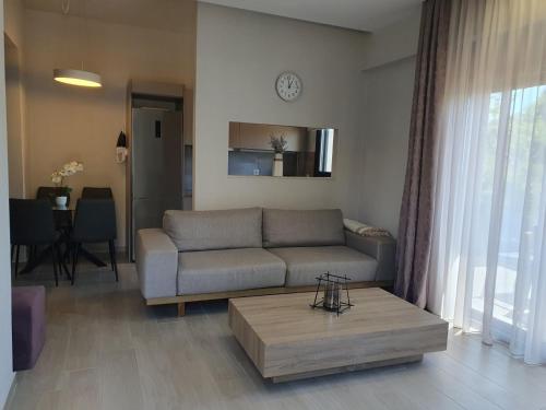 a living room with a couch and a coffee table at Villa Modern Nikiti in Nikiti