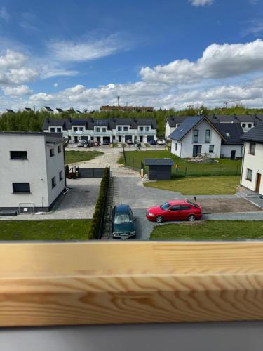 a view of a parking lot with cars and houses at Apartament Mariola in Gdańsk