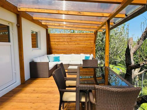 a patio with a couch and a table and chairs at Glamping Prokop in Prague