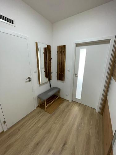 an empty room with a chair and a mirror at Sunny apartment BRNO in Medlánky