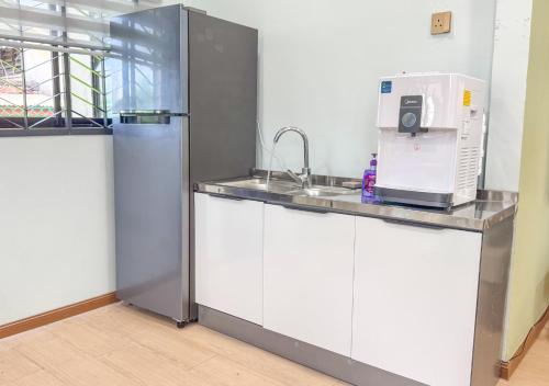 a kitchen with a sink and a refrigerator at Casa Azure Shah Alam in Shah Alam