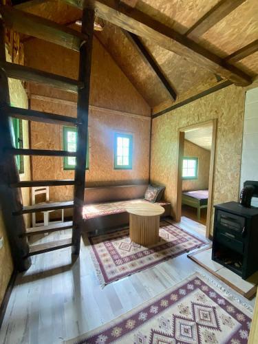 a room with a table and a stove in a room at Cottages of Nišići in Sarajevo
